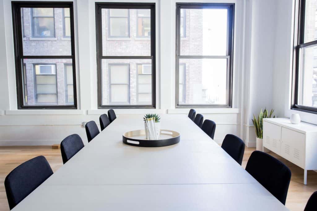 a photo of a conference room table and chairs