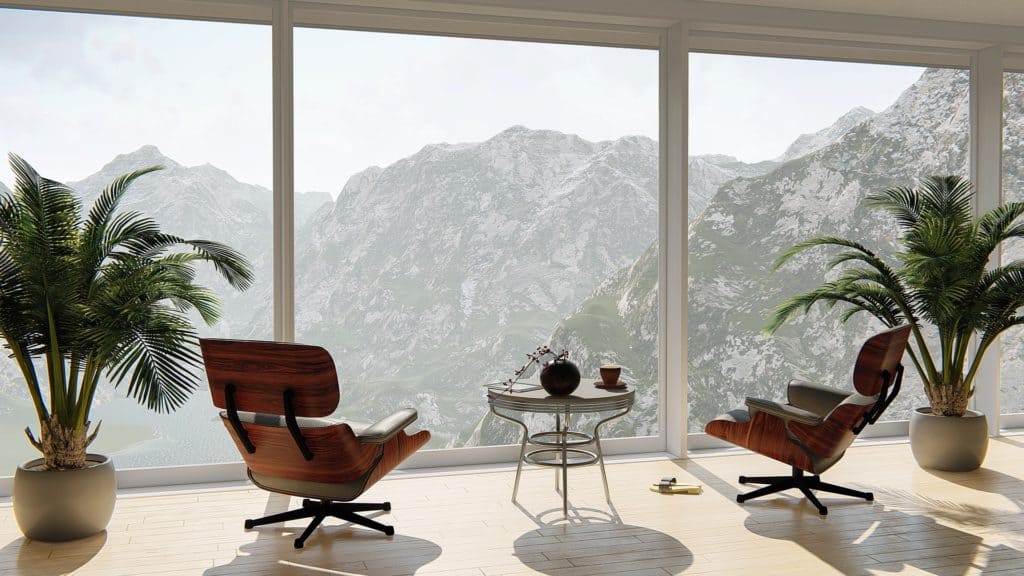 eames chairs looking out over view in the mountains