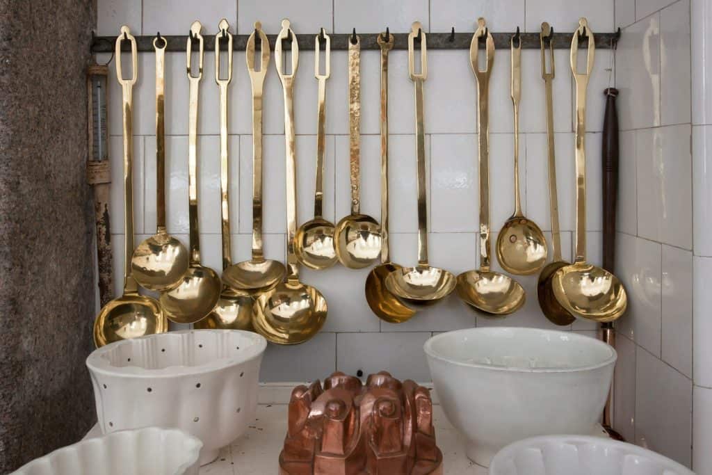 a photo of a kitchen counter with brass ladles