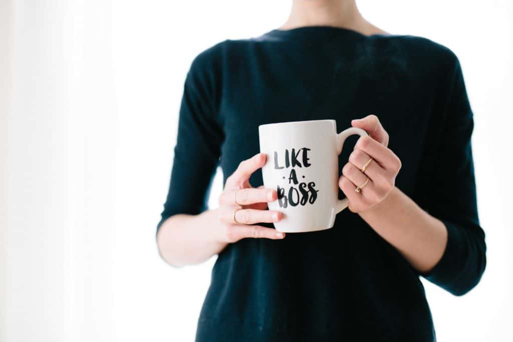 a girl holding a mug with the title of Like A Boss