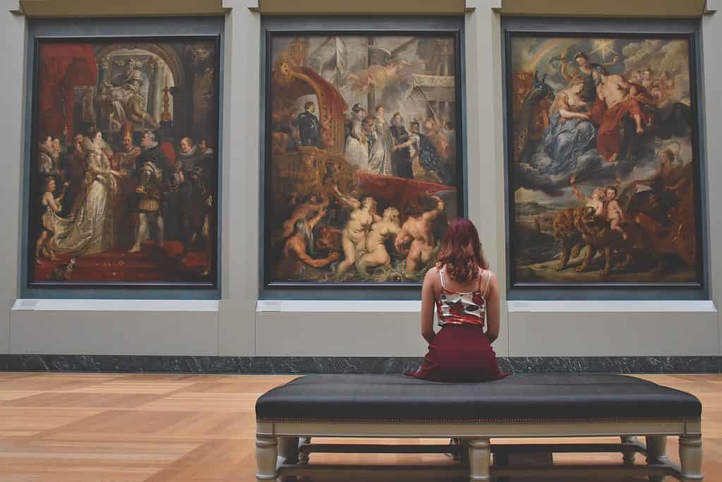a woman looking at art in a museum